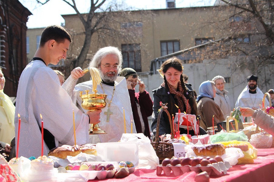 Священник освящает куличи